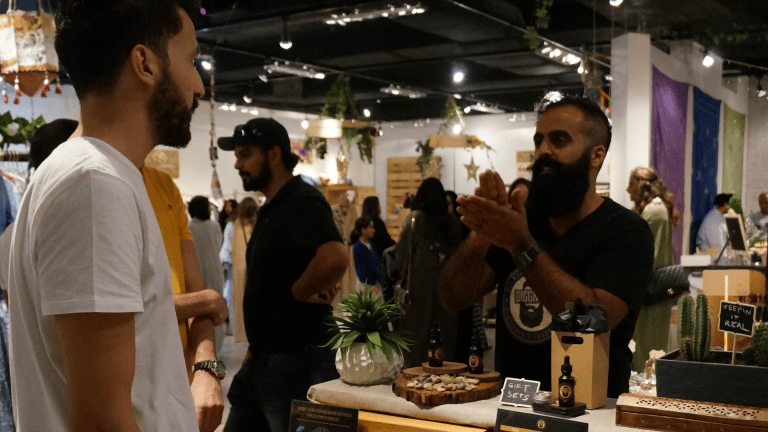 Waseem Sendi speaking with a customer at an early Diggn’It market event.