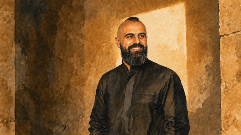 Watercolor portrait of Waseem Sendi with shaved sides, short textured hair, a full beard and small earrings, standing against warm stone between shadow and a rectangular shaft of light.